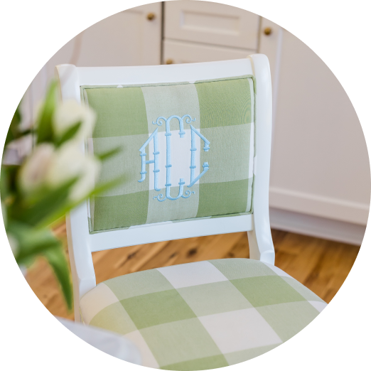 Custom upholstered barstool with green and white check fabric and light blue monogram. White wood kitchen barstool.